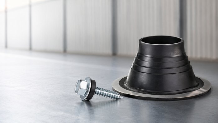 Metal roofing screws, closures, and sealant products arranged on a bench